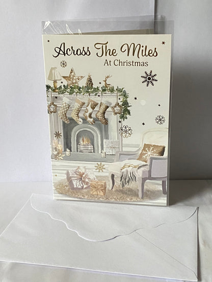 Across The Miles At Christmas Card White/Gold Stockings/Fireplace/Chair(PH50224A)